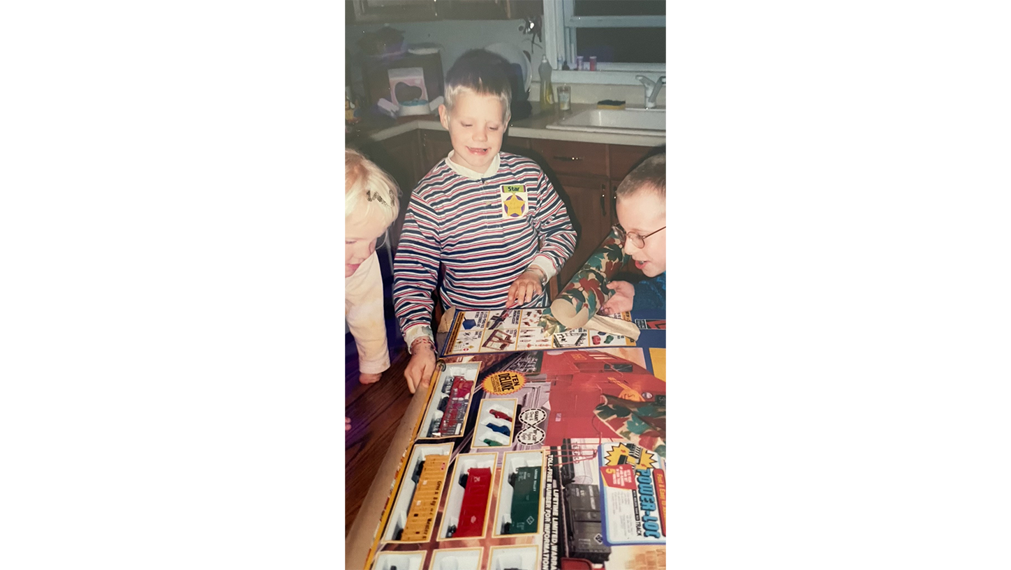 Young Brian playing with train set