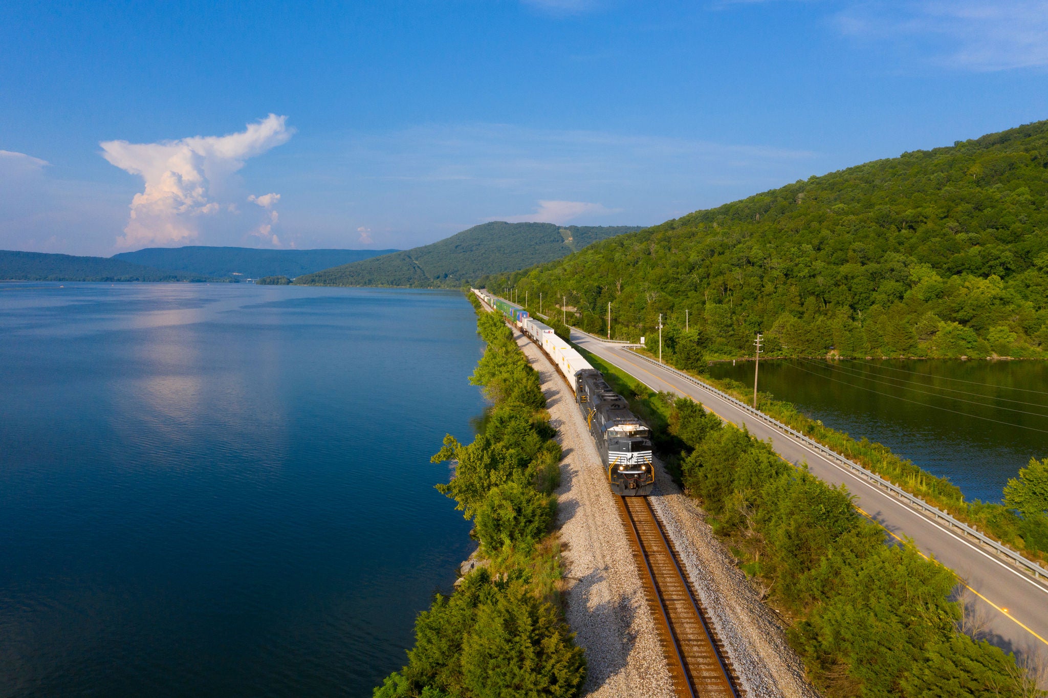 Ryan Markham, dispatcher, Atlanta. Markham’s first photo shows a mixed-freight train on a beautiful summer day skirting Nickajack Lake near Haletown, Tennessee, as a thunderstorm brewed in the distance. .
