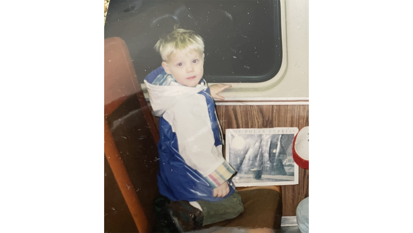 Young Brian riding a train