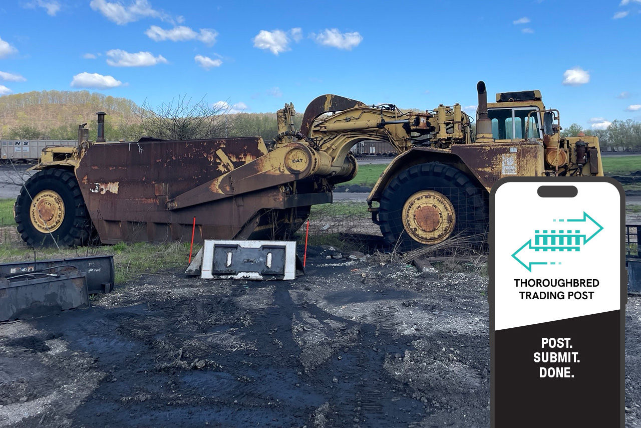 heavy machinery in rail yard with Thoroughbred Trading Post app superimposed